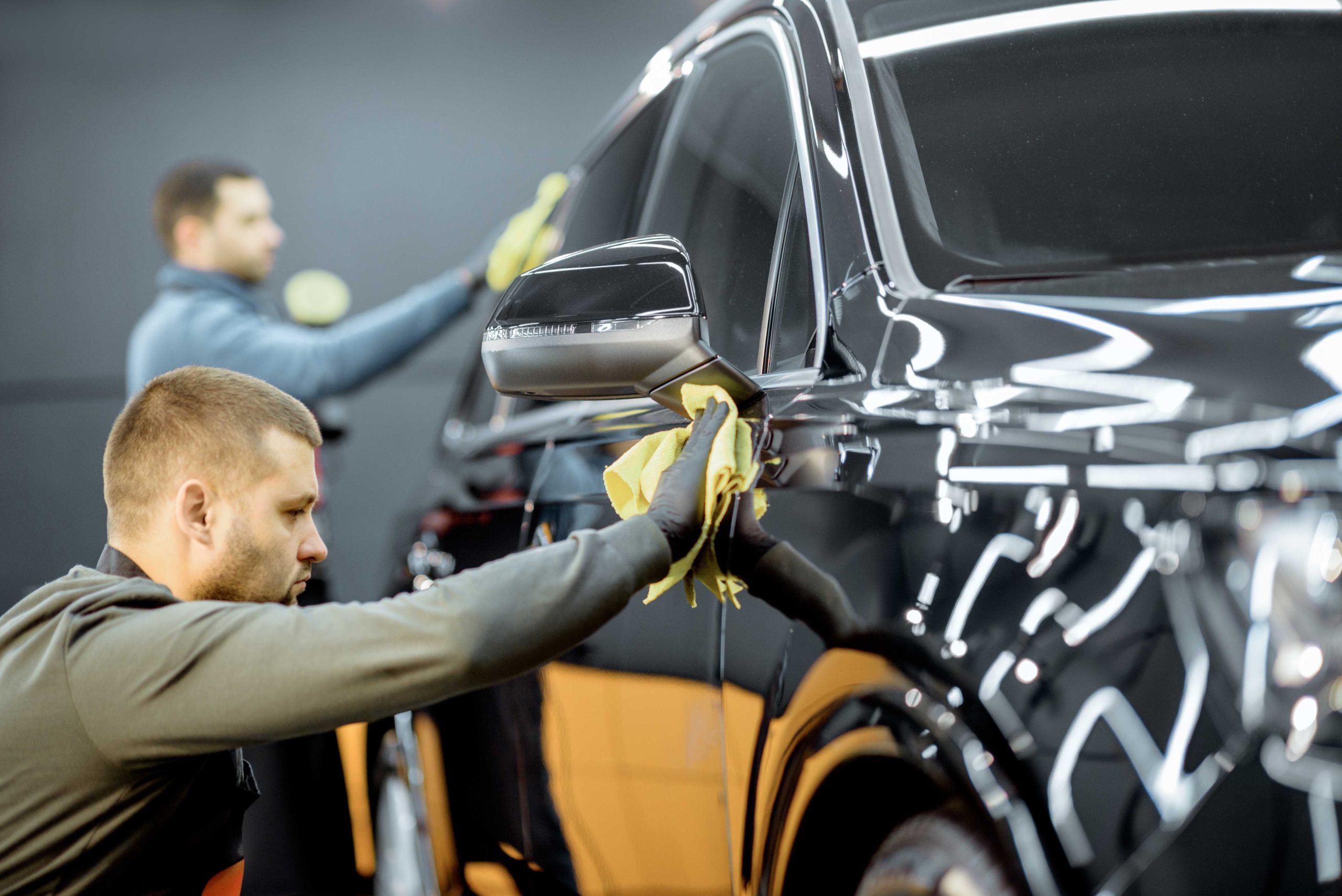 two professional exterior detailing worker