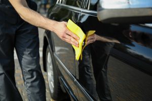 wiping car after exterior detailing