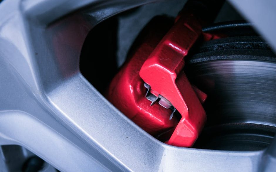 Close-up of a wheel being treated for brake dust removal with a pH-balanced cleaning solution