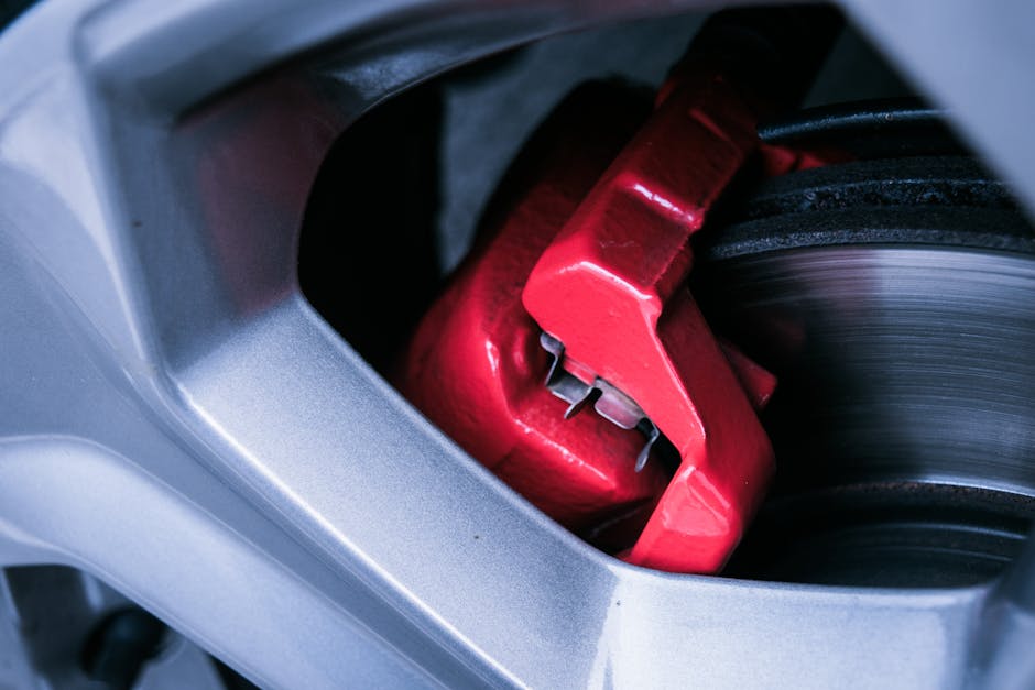 Close-up of a wheel being treated for brake dust removal with a pH-balanced cleaning solution