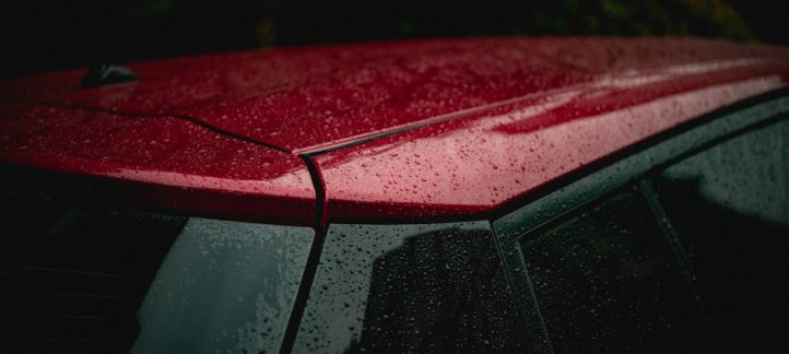 Water beading on a ceramic coated car hood showing hydrophobic protection