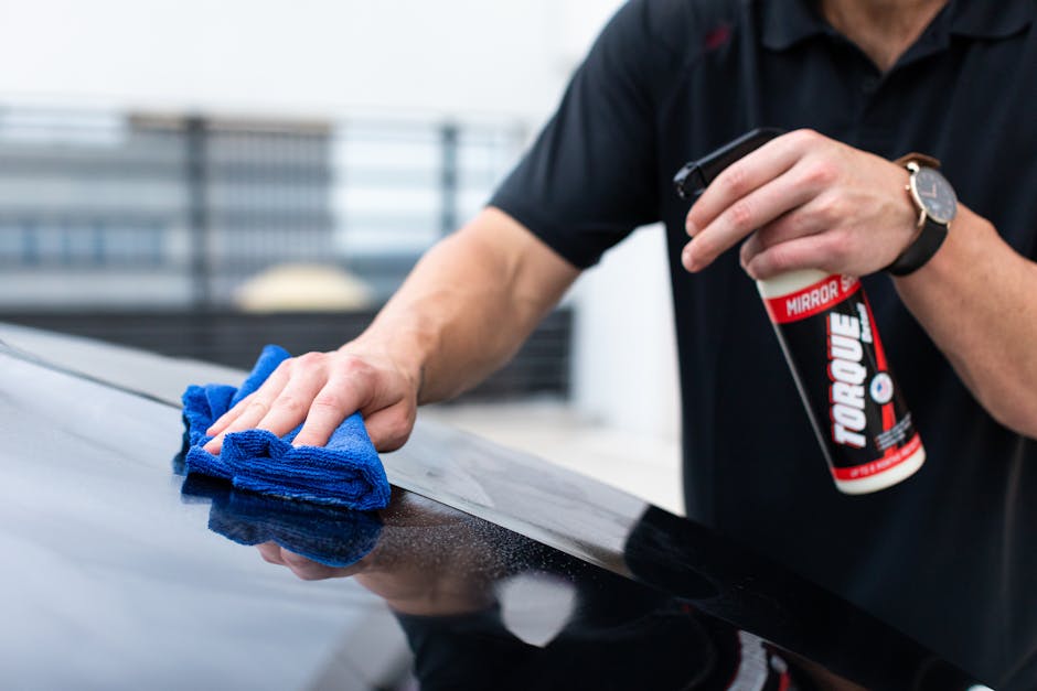 Mobile detailing technician hand washing a car at a customer's home in New Orleans