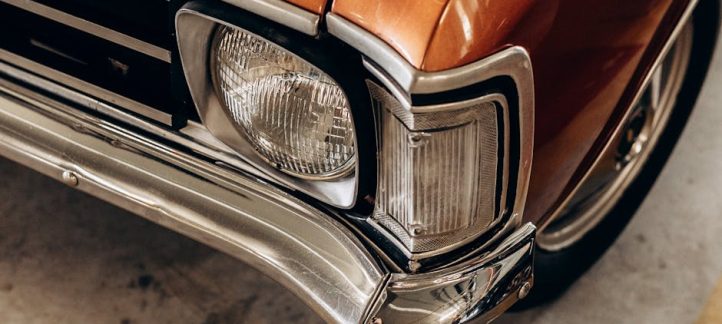 Close-up of a freshly restored headlight lens with a clear protective sealant applied