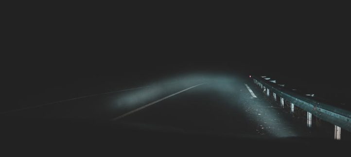 Comparison of a foggy yellowed headlight and a clear restored headlight on the same vehicle
