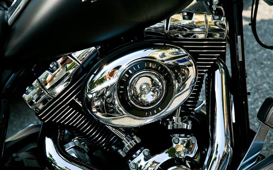 Detailer polishing the chrome and painted tank of a motorcycle in New Orleans