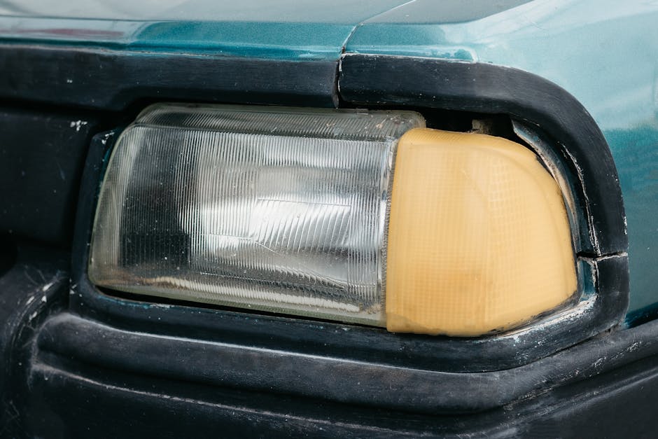 Oxidized and cloudy car headlight showing yellowing and UV damage that requires professional headlight restoration