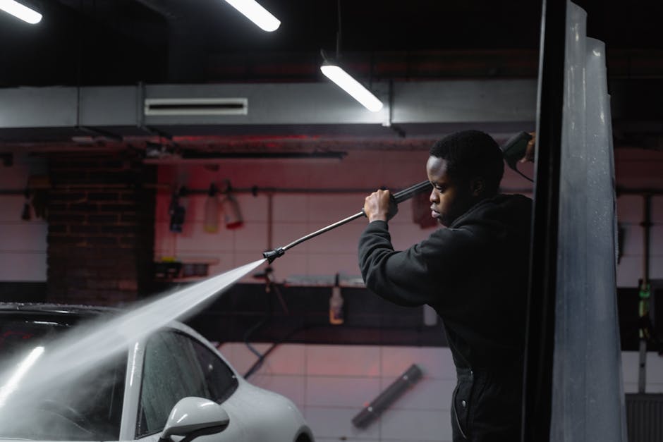 Touchless high-pressure rinse cleaning a dark vehicle without contact