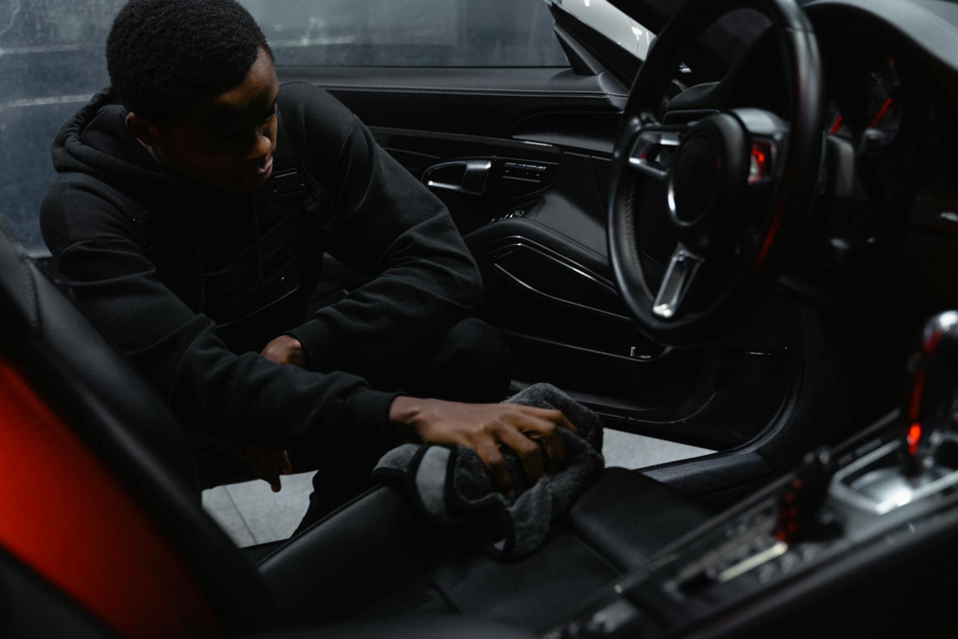 Big Easy Mobile Detail technician performing interior detailing in New Orleans — deep cleaning seats, carpets and dashboard